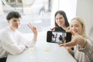 Happy friends taking selfie in a restaurant - AHSF00374