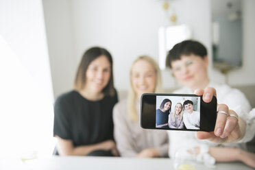 Happy friends taking selfie in a restaurant - AHSF00375