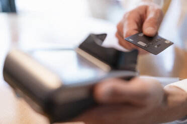 Man using credit card reader, close-up - DIGF07028