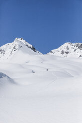 Austria, Tyrol, between Ischgl and Galtuer, Hohe Koepfe, ski tourer climbing up to the summit in winter - MMAF00927