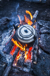 Boiling water pot over an open fire on a campsite on Tolbachik volcano, Kamchatka, Russia - RUNF02028