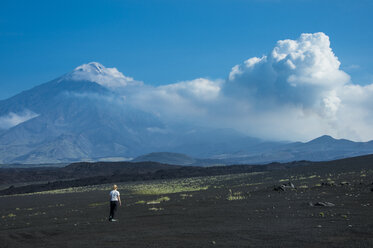 Woman watching Tolbachik volcano, Kamchatka, Russia - RUNF02046