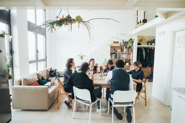 Businessmen and businesswomen celebrating at lunch party in loft office - CUF51305