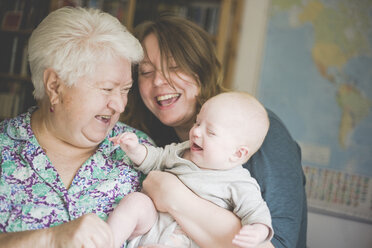 Happy grandmother with mother holding a baby girl - IHF00001