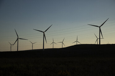 Spain, Andalusia, wind turbines at dusk - KBF00605
