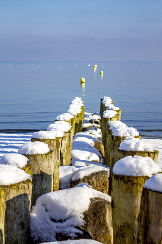 Schweiz, Arbon, Bodensee, Holzpfähle am Seeufer im Winter, lizenzfreies Stockfoto