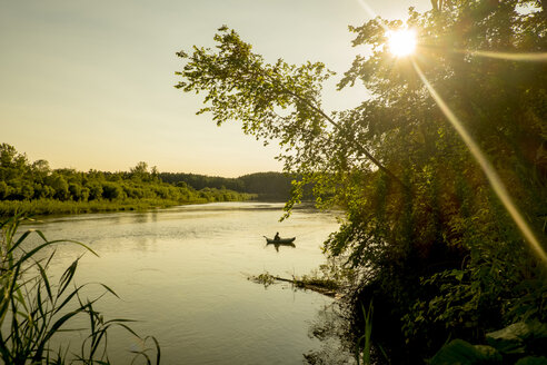 Distant Mari man fishing on lake, Ural, Russia - BLEF03252