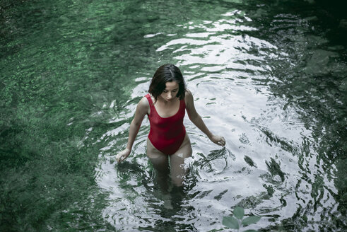 Caucasian woman wading in pool of water - BLEF03255