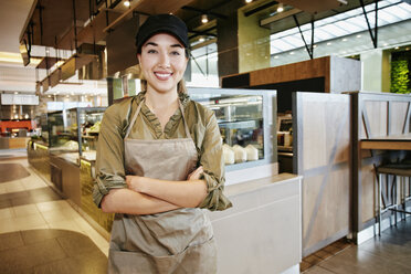 Portrait of smiling Mixed Race worker in food court - BLEF03291