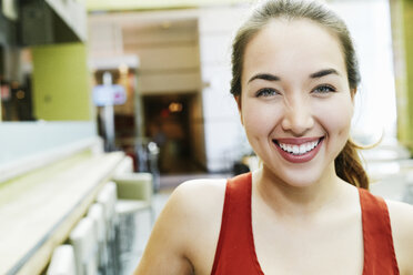 Smiling Mixed Race woman posing in food court - BLEF03297