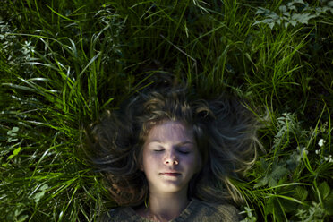Caucasian girl laying in grass - BLEF03358