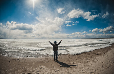 Caucasian boy cheering on ocean beach - BLEF03390