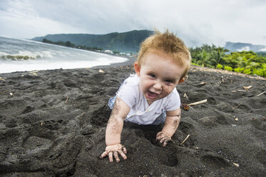 French Polynesia, Taharuu Beach, baby girl playing in black sand - RUNF02064