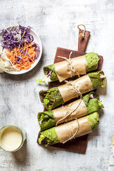 Lettuce wraps with spinach tortillas filled with lettuce, carrots and salad dressing - SBDF03960