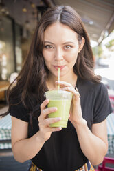 Thai woman drinking green smoothie - BLEF03401