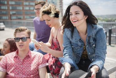 Friends sitting on bench in city - BLEF03438