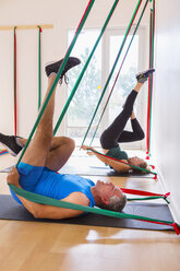 People using resistance bands in gymnasium - BLEF03485