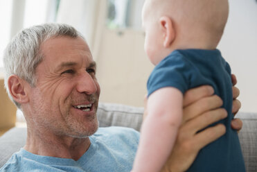 Caucasian grandfather holding grandson face to face - BLEF03520