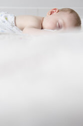 Caucasian baby boy sleeping on bed - BLEF03546