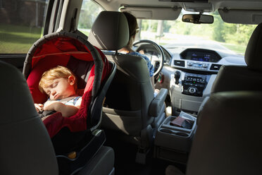 Kaukasische Mutter fährt Auto mit ihrem kleinen Sohn im Kindersitz - BLEF03606