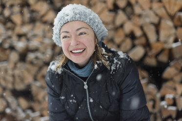 Porträt einer glücklichen Frau im Schneefall - PSIF00262