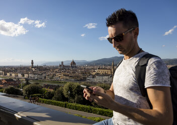 Man using his smartphone, Florence, Italy - MAUF02457