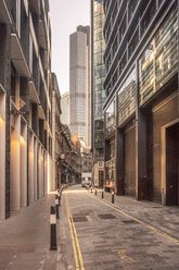 UK, London, narrow street in the City of London financial district with skyscrapers in the background - TAMF01482