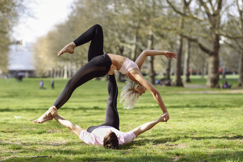 Free Photo  Young yoga lovers doing acrobatics
