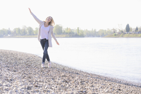 Carefree mature woman at the riverside stock photo