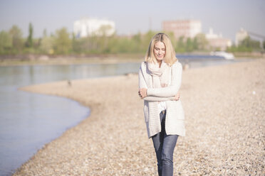 Mature woman walking at the riverside - UUF17547