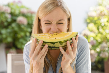 Woman eating watermelon outdoors - SHKF00804