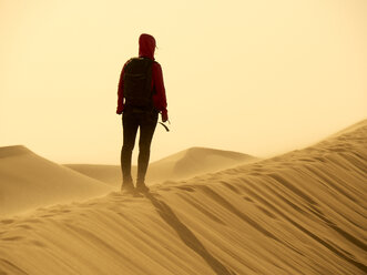 Back view of woman standing on dune in the Namib Desert, Namibia - VEGF00240