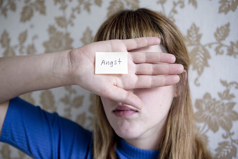 Student showing her hand, a note with the word fear on her hand - FLLF00183