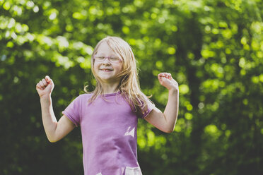 A jumping preschool girl with closed eyes - IHF00036