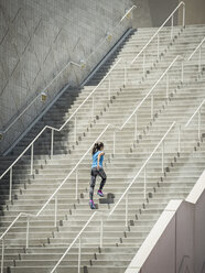 Caucasian woman running on staircase - BLEF03670