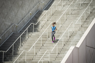 Caucasian woman running on staircase - BLEF03671