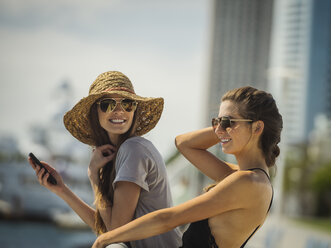 Caucasian women leaning on railing - BLEF03682