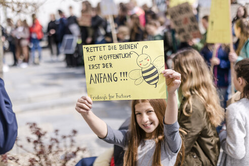 Girl holding a placard on a demonstration for environmentalism - STBF00354