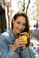 Young woman holding glass with fresh juice - AFVF02959