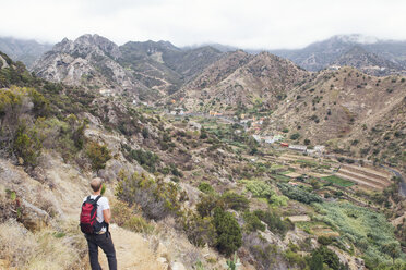Hiker enjoying the view, Vallehermoso, La Gomera, Canary Islands, Spain - MAMF00673