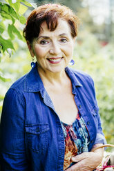 Caucasian woman smiling in garden - BLEF03899