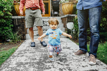 Gay fathers and baby son standing outdoors - BLEF03968