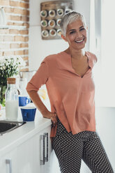 Older Caucasian woman smiling in kitchen - BLEF03978