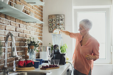 Ältere kaukasische Frau macht Smoothie in der Küche - BLEF03979