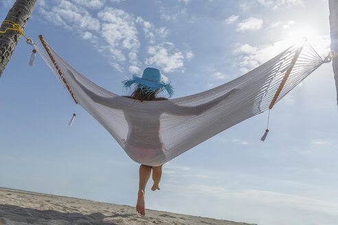 Caucasian woman in hammock at beach - BLEF04066