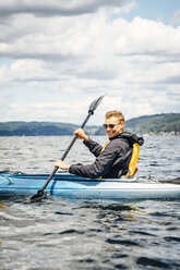 Caucasian man paddling kayak - BLEF04148