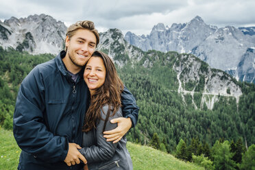Caucasian couple hugging neat mountain range, Tarvisio, Vienna, Austria - BLEF04174