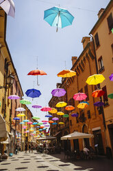 Multicolor umbrellas hanging over street, Bologna, Emilia-Romagna, Italy - BLEF04185