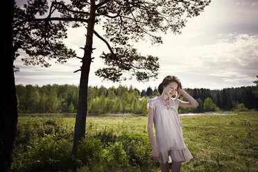 Pensive Caucasian girl standing in field - BLEF04302