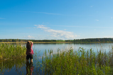 Caucasian woman wading in river - BLEF04420